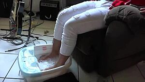 Asian woman enjoys messy barefoot foot bath