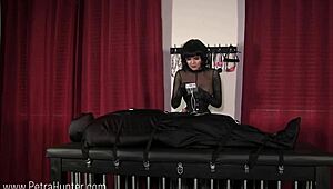 Bound, hooded, and shocked with electro domination by fierce mistress
