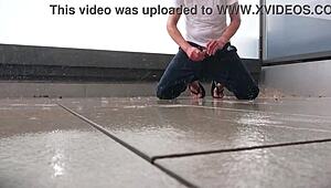 Masked babe jerks off wildly on wet balcony