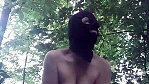 Female slave masturbates in outdoor forest bondage
