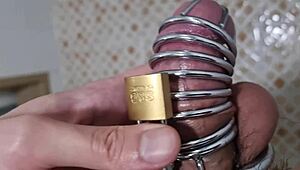 Korslaveman pees while wearing chastity belt on cock