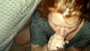 Hey, check out this redhead milf giving an amazing blowjob?