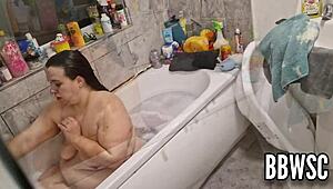 Pervert spies on BBW milf washing giant floppy tits in bath