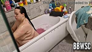 Pervert spies on BBW milf washing giant floppy tits in bath