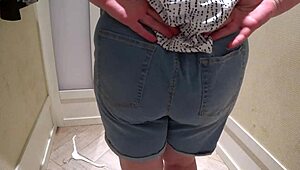 a hidden camera in the fitting room caught a mature chubby milf with a big booty trying on shorts.