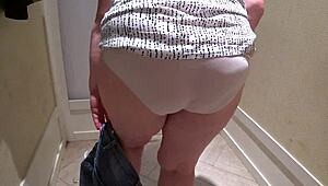 a hidden camera in the fitting room caught a mature chubby milf with a big booty trying on shorts.