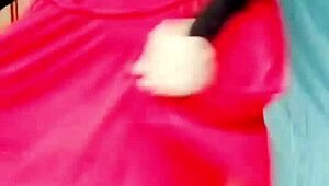 Pink shirt and black mini skirt on a sissy crossdresser with white legs