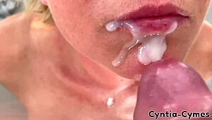 Housewife with big tits gives a sloppy blowjob while he watches porn on laptop. Massive cum in mouth!