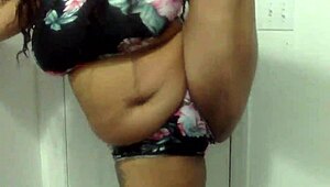 Big tit ebony milf dances in the bathroom, shaking her ass and tits around