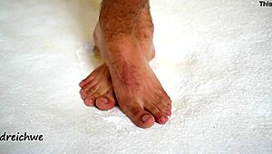 the sexy gay man shows off his huge high definition feet