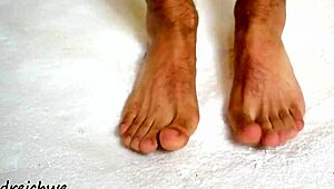 the sexy gay man shows off his huge high definition feet