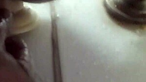 In the shower, he pleasures himself with a dildo