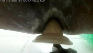 In the shower, he pleasures himself with a dildo