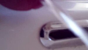 pissing in the sink with closeup