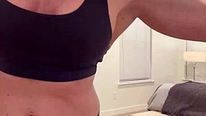 mature housewife bodybuilder flexing muscular body at home