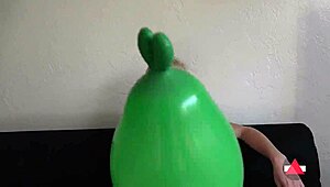 Giantess blonde model towers over toys and balloons, dominating with heels in wild play. Her tall frame rules!