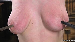 Busty redhead endures whipping and choking in bizarre bdsm bondage