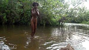 African girl bathes in river