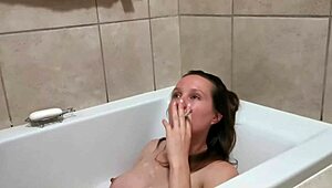 Petite amateur smokes in bath, exposing big tits and beautiful body.