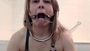 Intense humiliation of slave in harness with candle