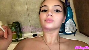 Smoking in bathtub, my big tits slave teen 18+ craves close-up attention. I feel so exposed!