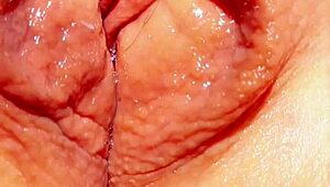 mature woman shows off her big wet vulva in close-up under skirt