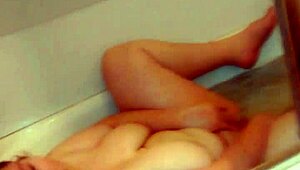 Gloria masturbating with dildo in bathtub
