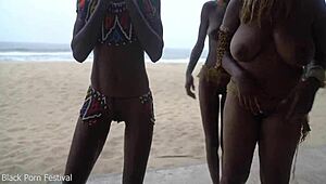 three african tribe witches perform a dancing ritual to make rain
