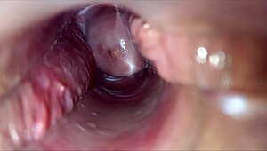 horny woman uses speculum for pulsating orgasm inside vagina.