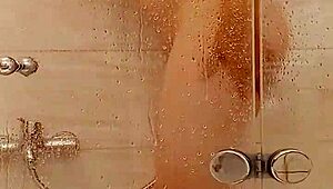 She caresses herself in the bath with big tits and ass