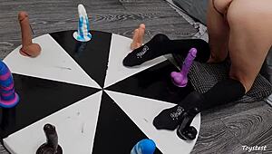 She spins the wheel of dildos to win her orgasm