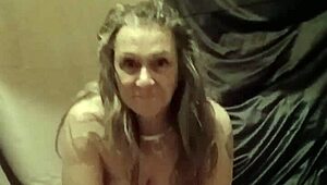 Female slave indulges in solo striptease session with toys and bondage in homemade outdoor setting