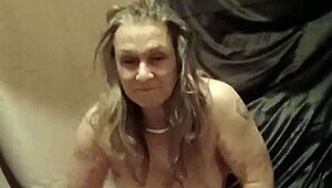 Female slave indulges in solo striptease session with toys and bondage in homemade outdoor setting