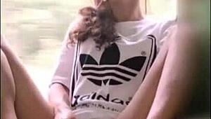 Cute girl enjoys a lollipop on the train with friends