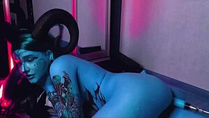 Tattooed blue-eyed slut with huge tits gets pounded by machine.