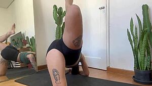 An inked girl warms up with rubber bands for her yoga fitness routine.