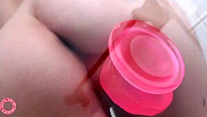 Samantha Rone pounds her pink toy in the shower.