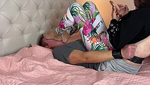 The foot slave is captured beneath the Asian dominatrix's feet in bondage