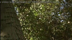 outdoor milf cougar fingers shaved pussy then straps on for lesbian anal assfuck between trees