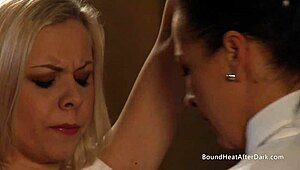 blonde slave kneels bound as dom madame gropes her big tits and pussy