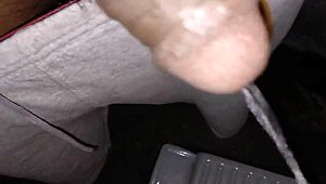 Indian stud pisses hot stream in bathroom stroking massive black cock to orgasm