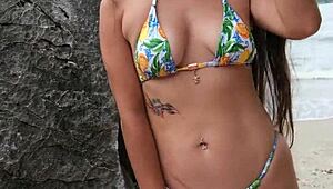 This petite tanned girl next door dances bikini on tropical beach, flashing ass casually