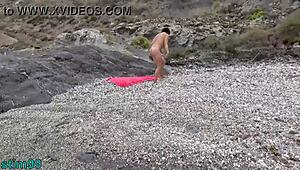 Mature Woman Inserts Stone In Pussy And Ass On Nudist Beach